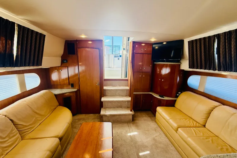 Slide: The Image of Luxurious interior of 2001 Carver 444 Cockpit Motor Yacht with leather seating and wood finishes. - 13
