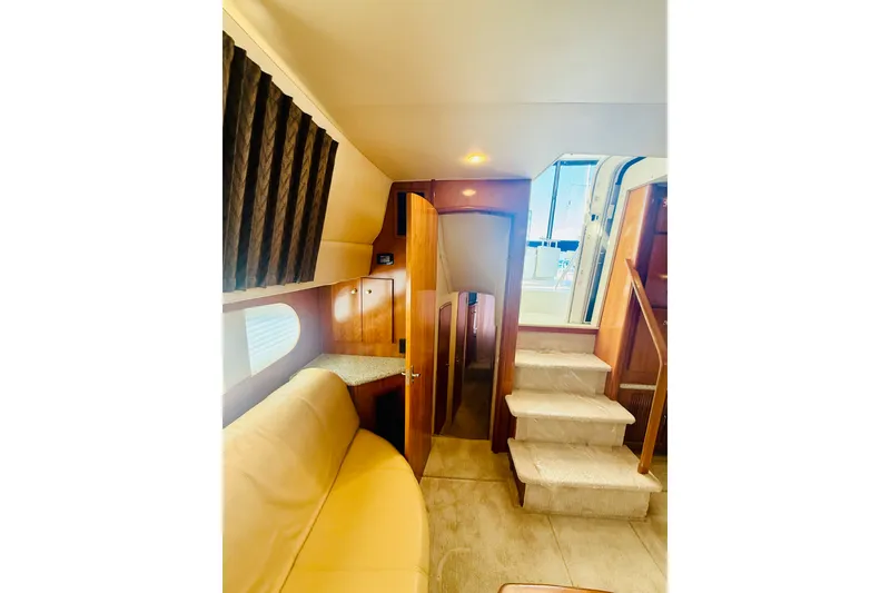 Slide: The Image of Interior of 2001 Carver 444 Cockpit Motor Yacht with stairs and seating area. - 20