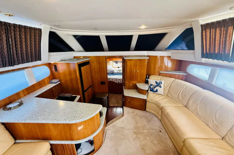 Slide: The Image of Luxurious interior of 2001 Carver 444 Cockpit Motor Yacht with plush seating and elegant wood finishes. - 16