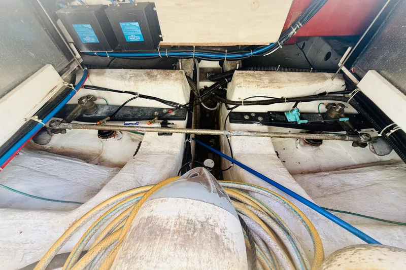 Slide: The Image of Engine compartment of a 2001 Carver 444 Cockpit Motor Yacht with visible wiring and components. - 24