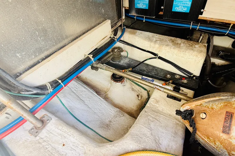 Slide: The Image of Engine compartment of a 2001 Carver 444 Cockpit Motor Yacht with visible wiring and components. - 27