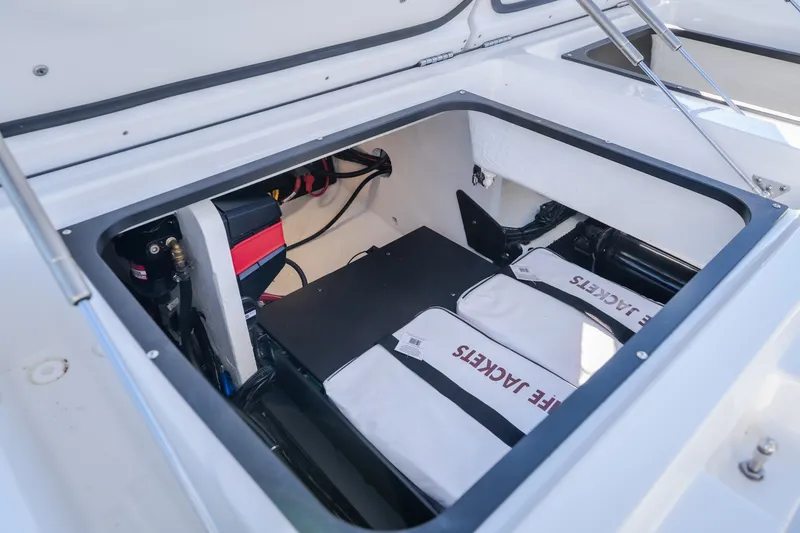 Slide: The Image of Storage compartment of 2026 Monterey Elite 30 OB boat with life jackets and equipment. - 38