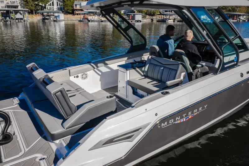 Slide: The Image of 2026 Monterey Elite 30 OB boat on water, featuring spacious seating and modern design. - 8
