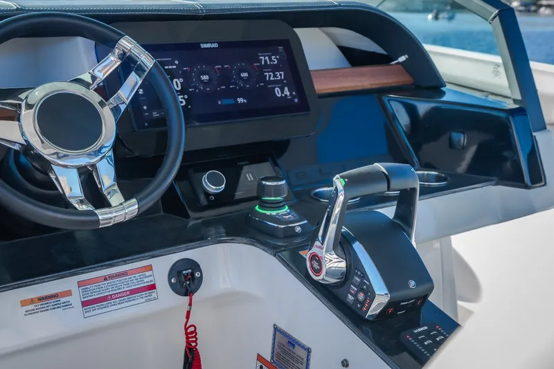 Slide: The Image of Helm of 2026 Monterey Elite 30 OB boat with modern controls and display. - 18