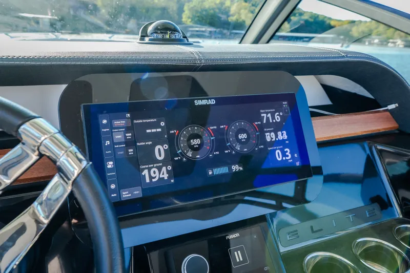 Slide: The Image of Dashboard of 2026 Monterey Elite 30 OB boat with digital display and controls. - 19