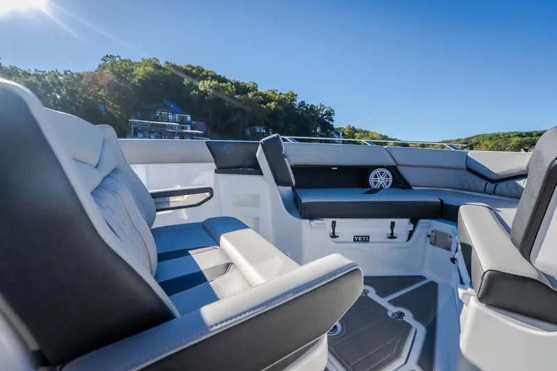 Slide: The Image of Luxurious seating on the 2026 Monterey Elite 30 OB boat under clear blue skies. - 47