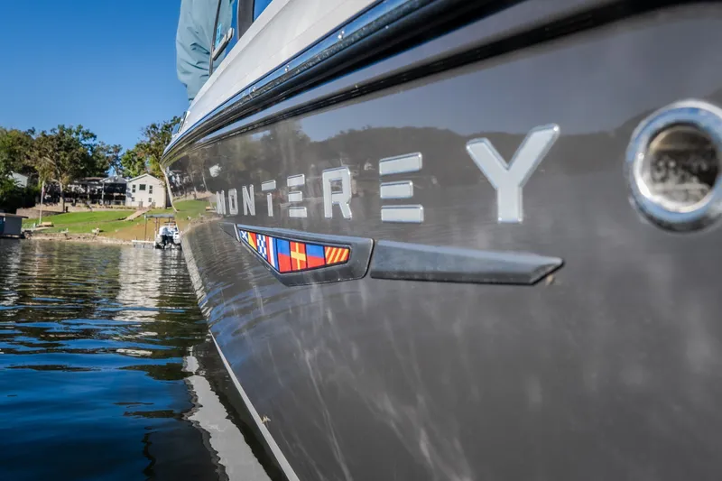 Slide: The Image of 2026 Monterey Elite 30 OB boat on calm water, showcasing sleek design and branding. - 62