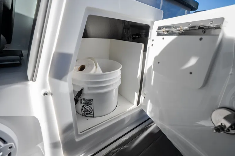 Slide: The Image of Storage compartment on 2026 Monterey Elite 30 OB boat with bucket and paper towels. - 41