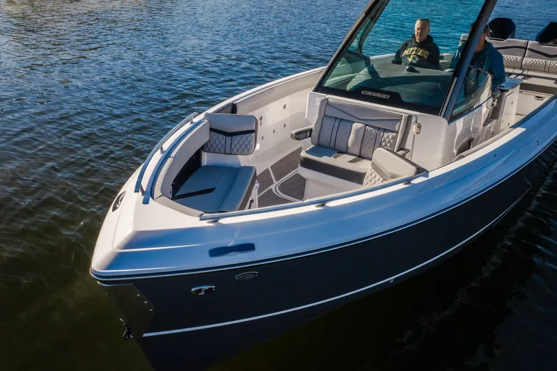 Slide: The Image of 2026 Monterey Elite 30 OB boat on water, featuring sleek design and spacious seating. - 7