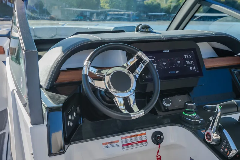 Slide: The Image of Steering console of 2026 Monterey Elite 30 OB boat with digital display and controls. - 17