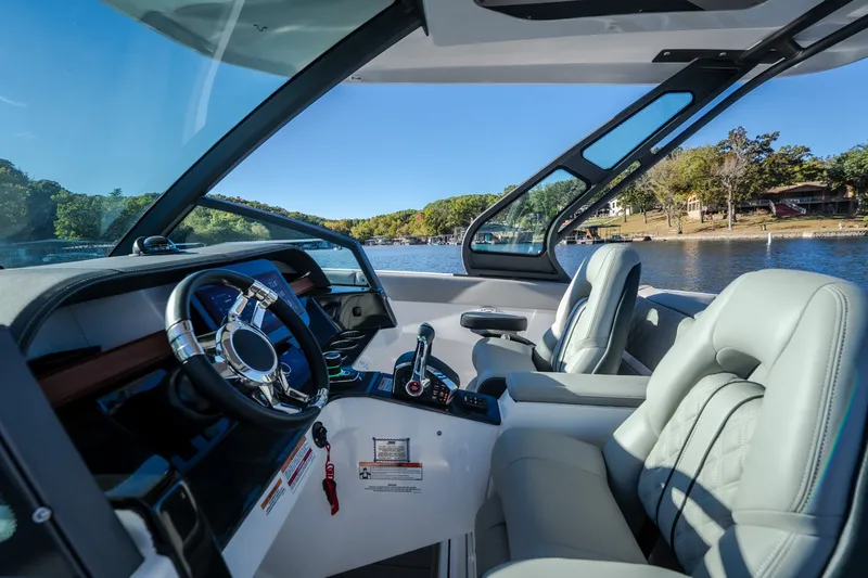 Slide: The Image of 2026 Monterey Elite 30 OB boat interior with steering wheel and luxurious seating. - 15
