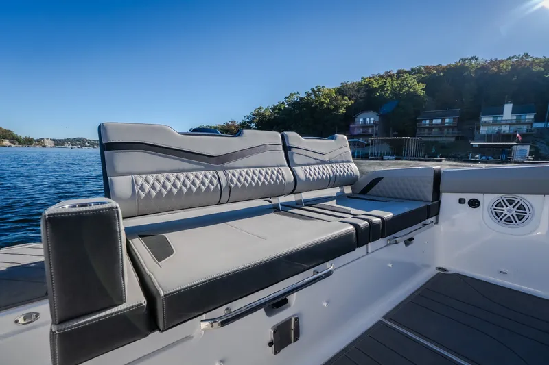Slide: The Image of Luxurious seating on 2026 Monterey Elite 30 OB boat, with scenic waterfront view. - 28