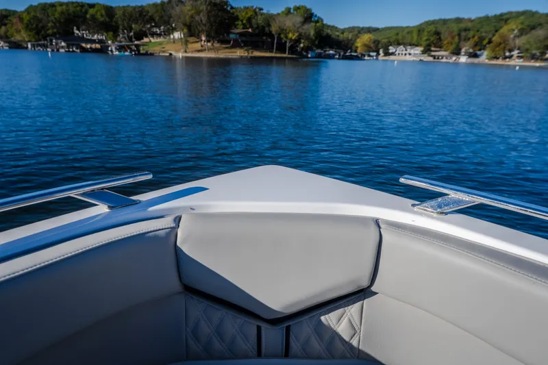 Slide: The Image of Bow view of 2026 Monterey Elite 30 OB on a serene lake. - 51