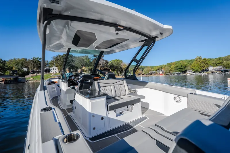Slide: The Image of 2026 Monterey Elite 30 OB boat interior on a scenic lake. - 12