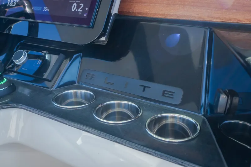 Slide: The Image of Dashboard of 2026 Monterey Elite 30 OB boat with control panel and cup holders. - 26
