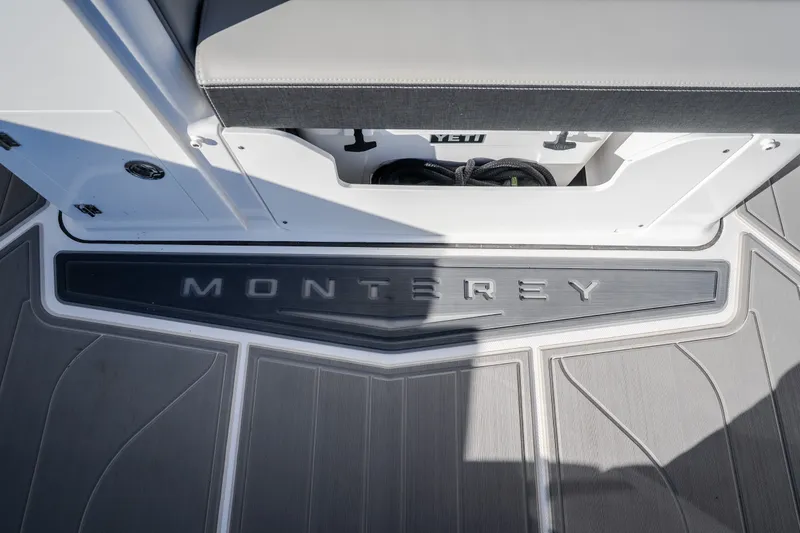 Slide: The Image of 2026 Monterey Elite 30 OB boat deck with logo and storage compartment. - 36