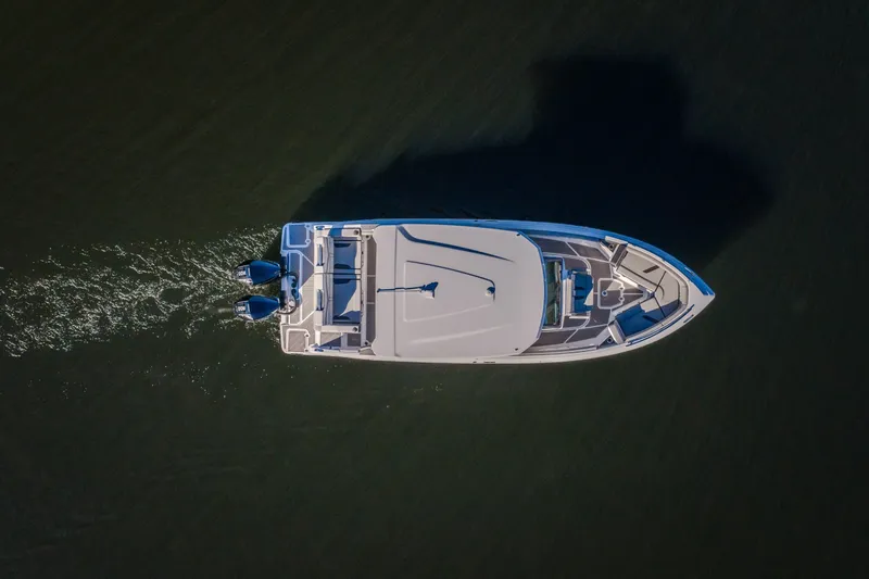 Slide: The Image of Aerial view of 2026 Monterey Elite 30 OB boat cruising on water. - 65