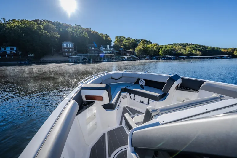 Slide: The Image of 2026 Monterey Elite 30 OB boat on a serene lake with sunny skies. - 57