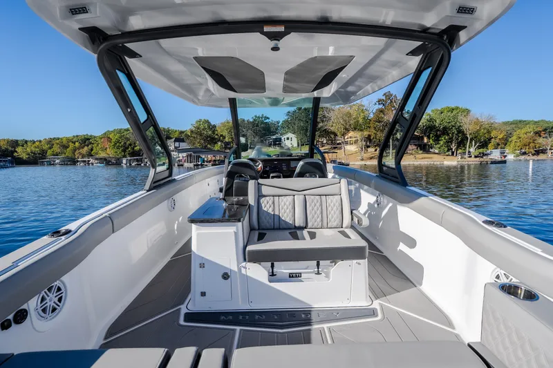 Slide: The Image of 2026 Monterey Elite 30 OB boat interior with seating, lake view, and modern design. - 11
