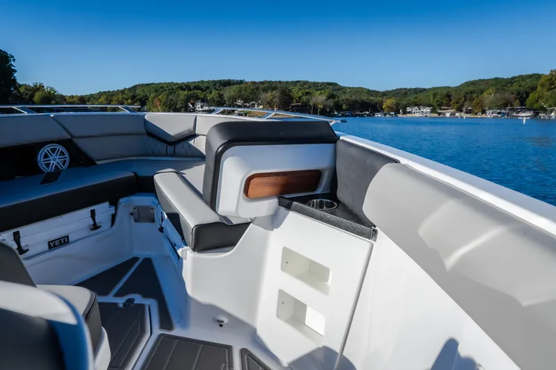 Slide: The Image of 2026 Monterey Elite 30 OB boat interior with seating, cup holders, and scenic lake view. - 46