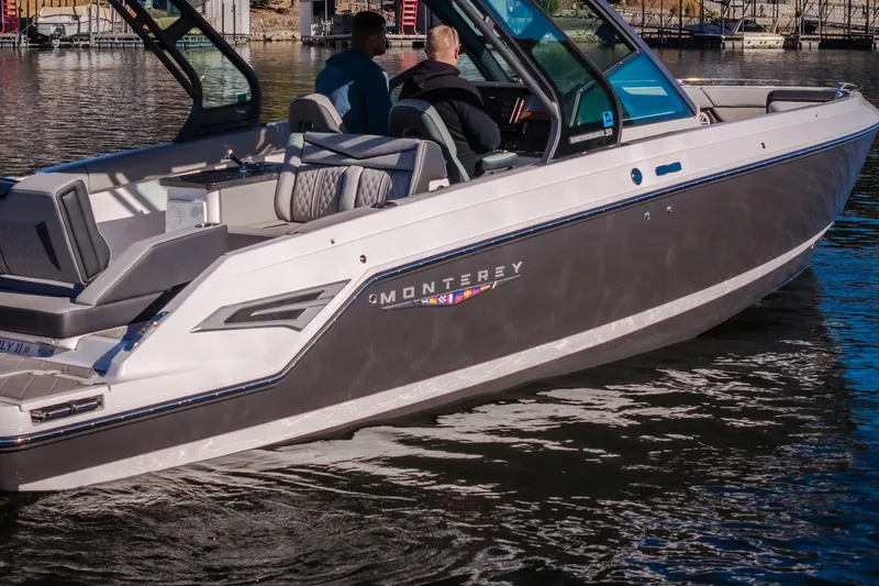 Slide: The Image of 2026 Monterey Elite 30 OB boat on water, featuring sleek design and modern amenities. - 72
