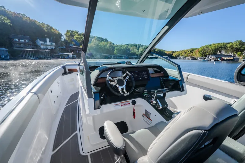 Slide: The Image of 2026 Monterey Elite 30 OB boat interior with modern dashboard and scenic lake view. - 16