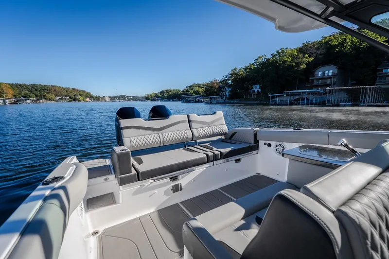 Slide: The Image of Luxurious 2026 Monterey Elite 30 OB boat interior on a serene lake. - 27