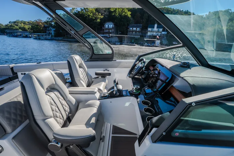 Slide: The Image of Luxurious interior of 2026 Monterey Elite 30 OB boat with modern dashboard and seating. - 60