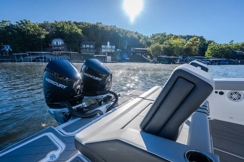 Slide: The Image of 2026 Monterey Elite 30 OB boat with dual Mercury engines on a sunny lake. - 31