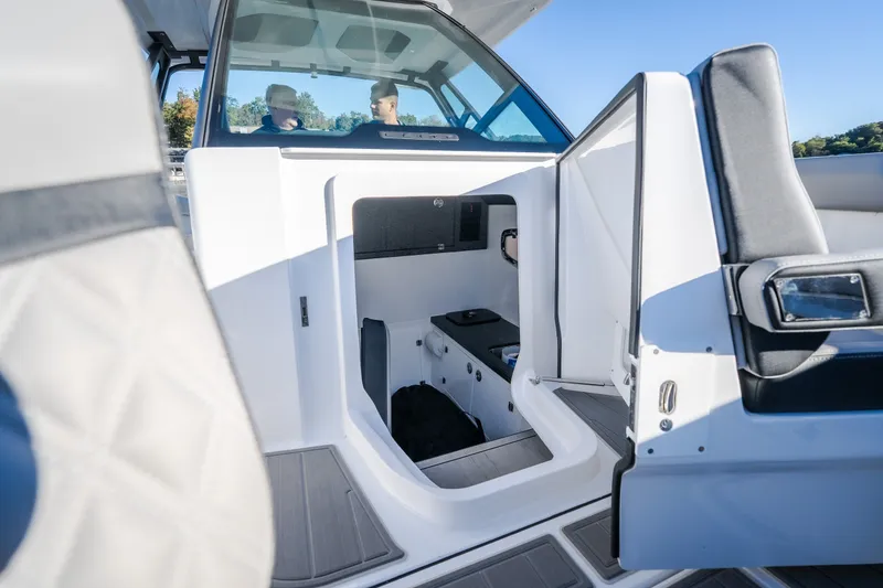 Slide: The Image of 2026 Monterey Elite 30 OB boat interior with seating and storage area. - 53