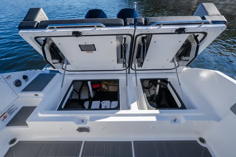 Slide: The Image of 2026 Monterey Elite 30 OB boat with open storage compartments on the deck. - 37