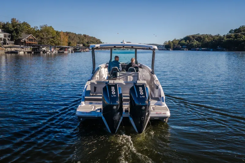 Slide: The Image of 2026 Monterey Elite 30 OB boat cruising on a serene lake. - 67