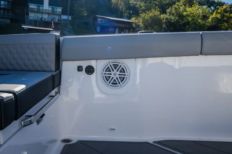 Slide: The Image of Interior of 2026 Monterey Elite 30 OB boat with speaker and cushioned seating. - 29