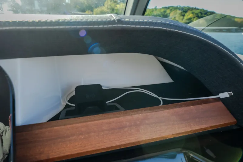 Slide: The Image of Dashboard of 2026 Monterey Elite 30 OB boat with charging station and scenic view. - 21