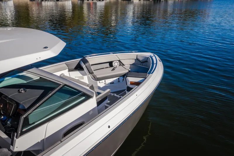 Slide: The Image of 2026 Monterey Elite 30 OB boat on calm water, showcasing sleek design and spacious seating. - 6