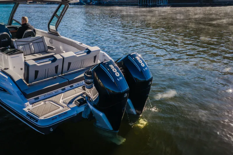 Slide: The Image of 2026 Monterey Elite 30 OB boat with dual Mercury 300 V8 engines on a calm lake. - 4