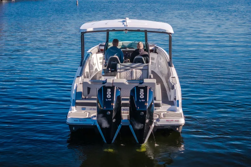 Slide: The Image of 2026 Monterey Elite 30 OB boat with dual 300 V8 engines on calm water. - 9