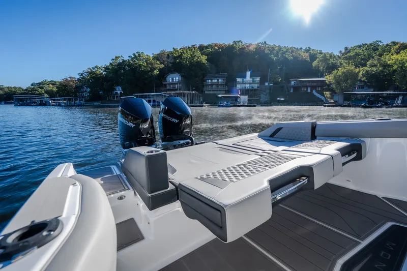 Slide: The Image of 2026 Monterey Elite 30 OB boat with dual Mercury engines on a sunny lake. - 33