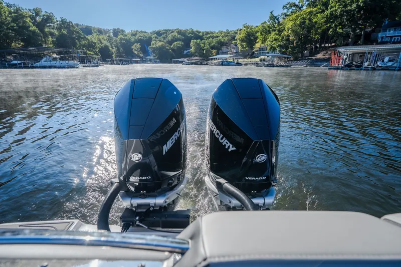 Slide: The Image of 2026 Monterey Elite 30 OB boat with dual Mercury outboard engines on a serene lake. - 64