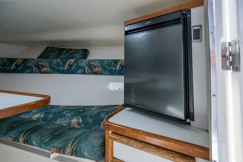 Slide: The Image of 2004 Jupiter 31 Cuddy cabin interior with bed and compact refrigerator. - 7