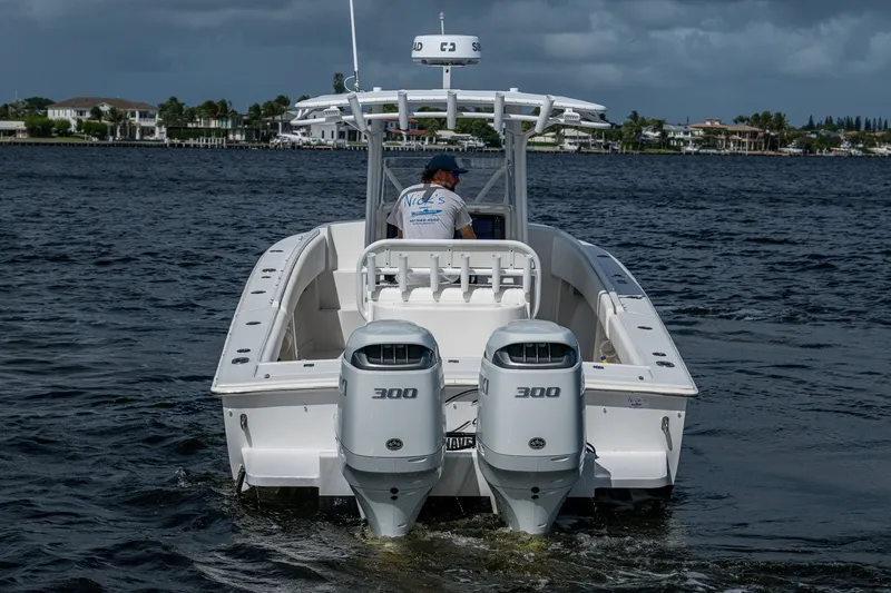 Slide: The Image of 2004 Jupiter 31 Cuddy boat with dual 300 horsepower engines on the water. - 4