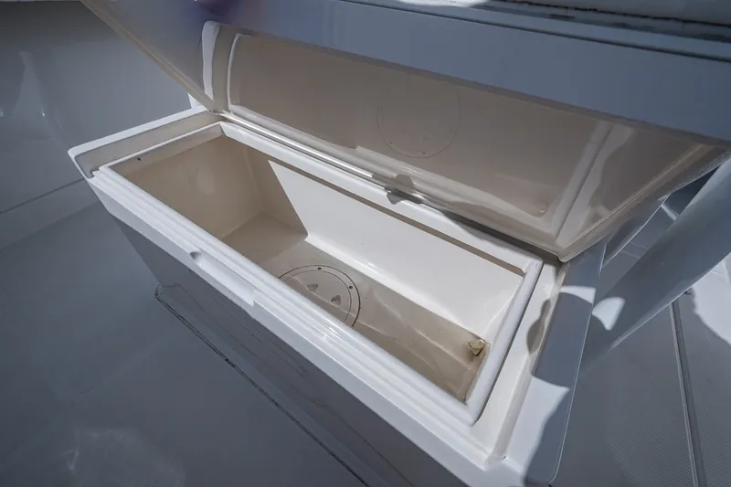 Slide: The Image of Open storage compartment on 2004 Jupiter 31 Cuddy boat, showcasing interior space. - 9