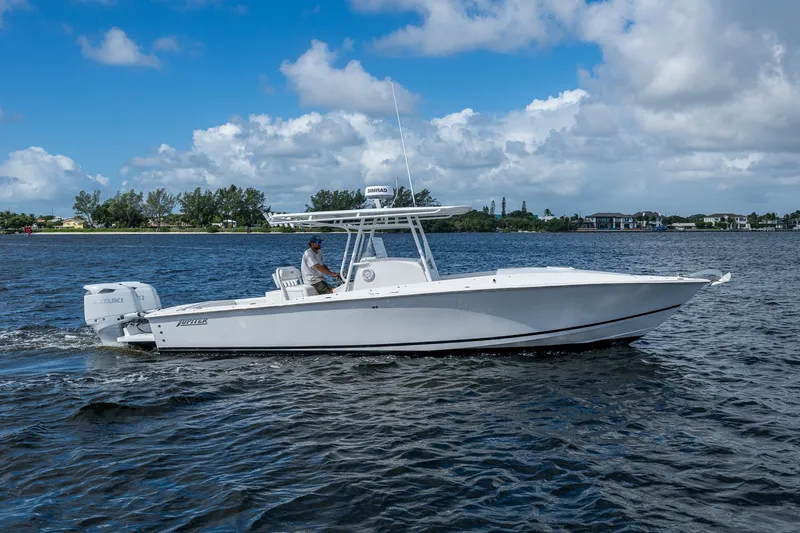 The Image of 2004 Jupiter 31 Cuddy boat cruising on a sunny day with clear skies. - 0