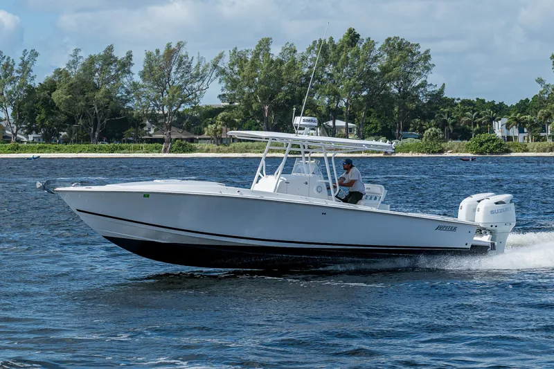Slide: The Image of 2004 Jupiter 31 Cuddy boat cruising on a scenic waterway. - 1