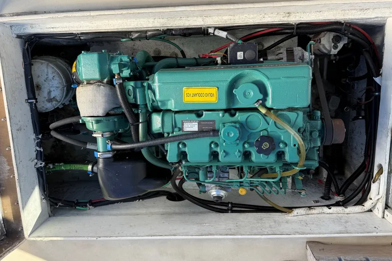 Slide: The Image of Engine compartment of a 2002 Mitchell Sea Angler boat, featuring a green marine engine. - 17