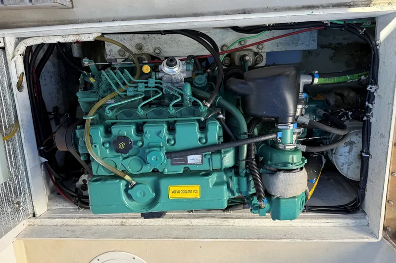 Slide: The Image of Engine compartment of a 2002 Mitchell Sea Angler boat, featuring a Volvo marine engine. - 16