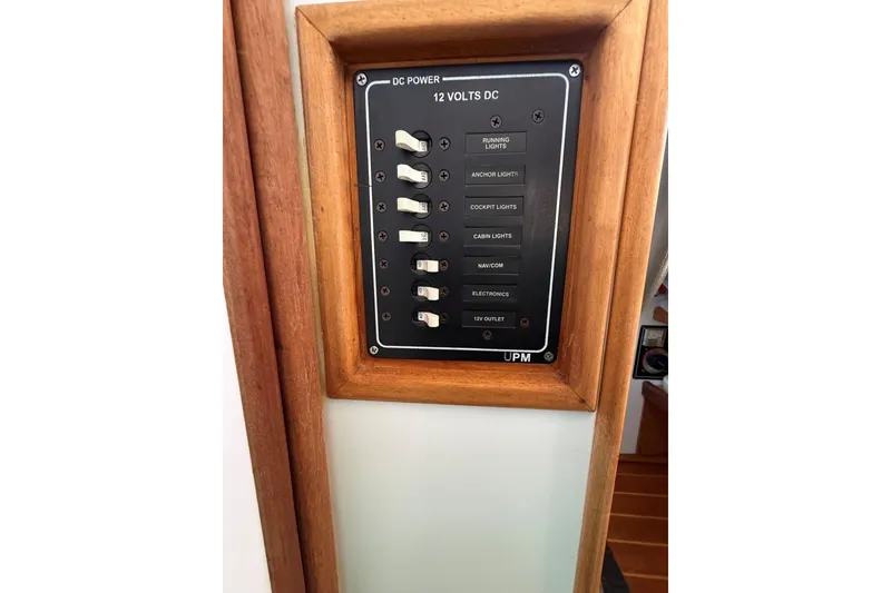 Slide: The Image of Control panel on a 2002 Mitchell Sea Angler boat, featuring various light switches. - 11