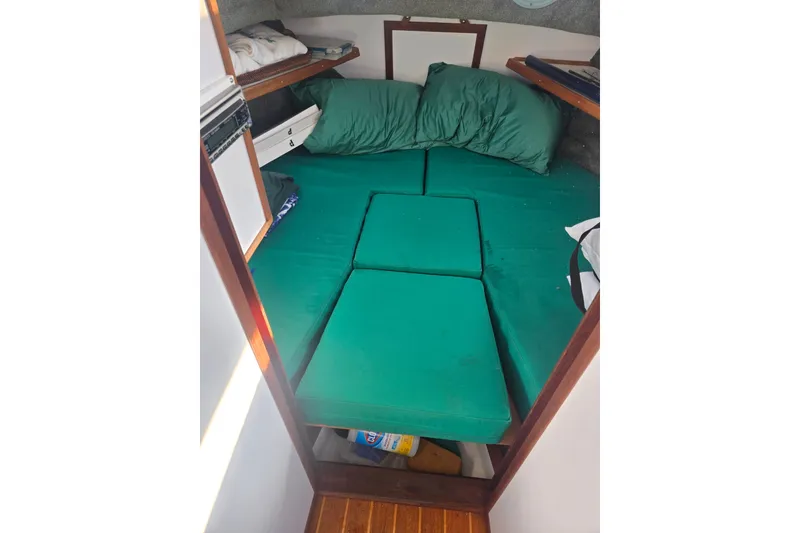 Slide: The Image of Cozy cabin interior of 2002 Mitchell Sea Angler with green cushions and wooden flooring. - 13