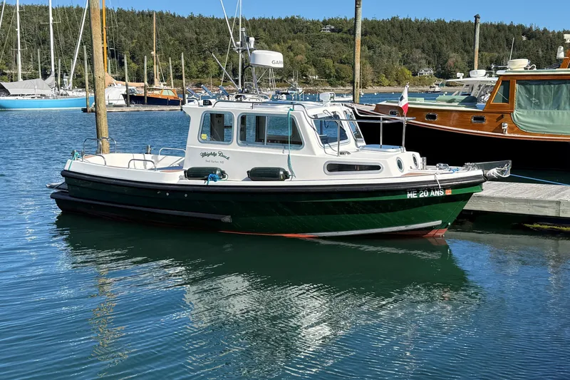 Slide: The Image of 2002 Mitchell Sea Angler boat docked in a serene marina setting. - 5