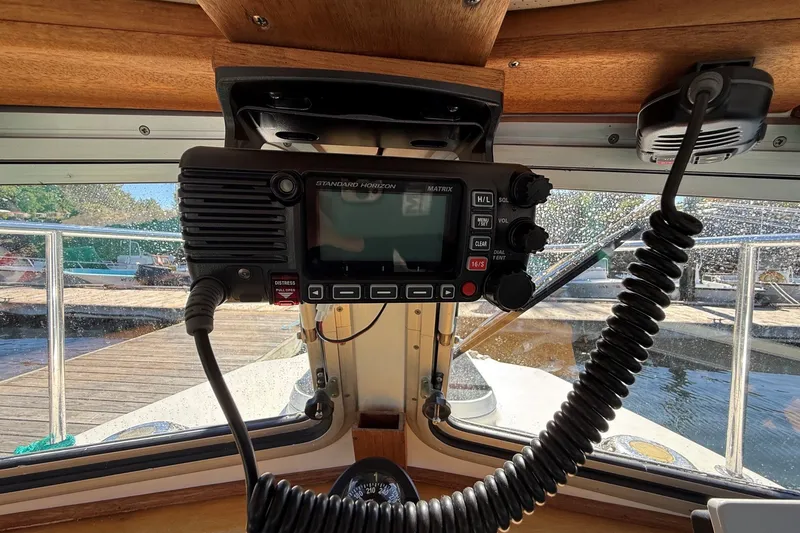 Slide: The Image of Boat cockpit with Standard Horizon radio, Mitchell Sea Angler 2002, dock view through window. - 10